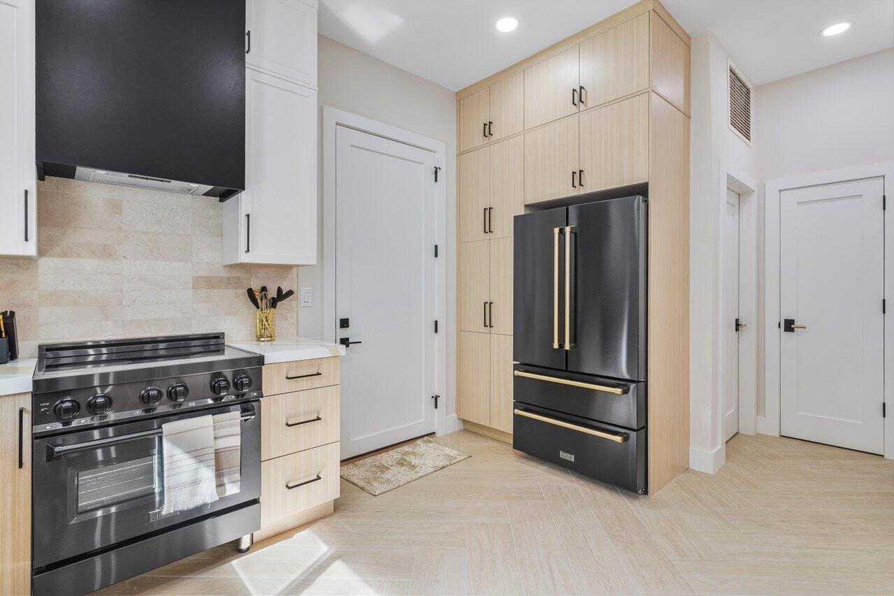 1920 Spanish Trail Delray Beach, FL 33483 - Photo 13 of 23 a kitchen with stainless steel appliances and cabinets