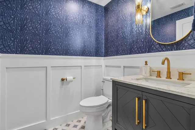 a bathroom with a sink a toilet and mirror