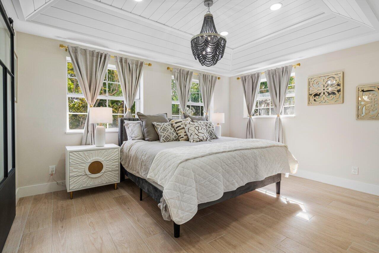 1920 Spanish Trail Delray Beach, FL 33483 - Photo 15 of 23 a bedroom with a bed and a large window