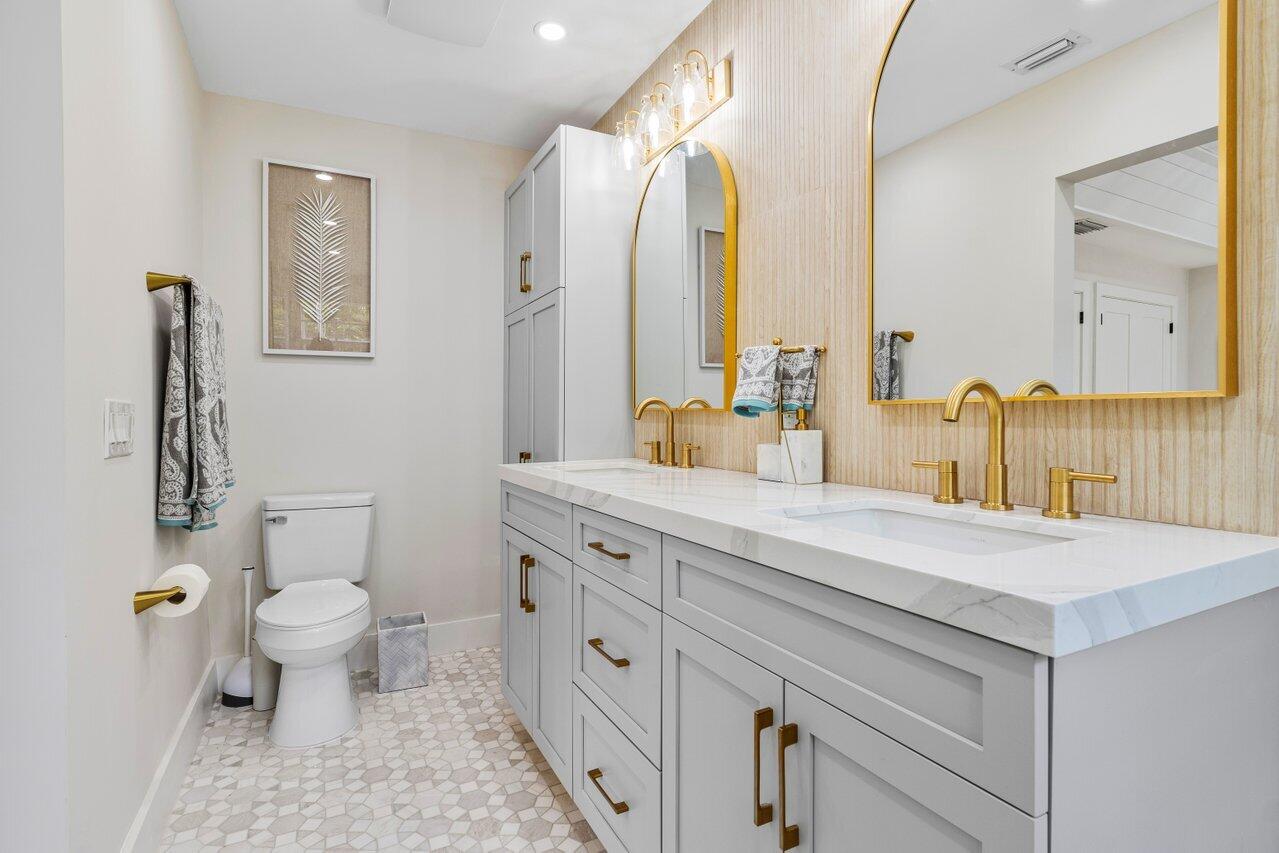 1920 Spanish Trail Delray Beach, FL 33483 - Photo 19 of 23 a bathroom with a sink a toilet and a mirror