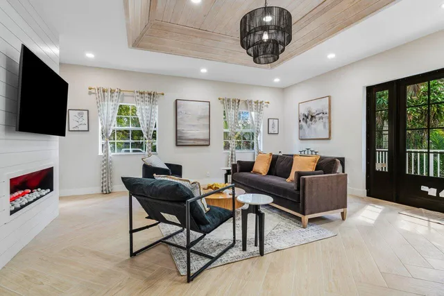 a living room with furniture a flat screen tv and a fireplace