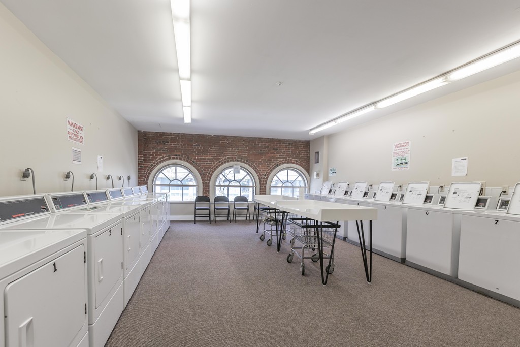 106 13th Street, Unit 204 Boston, MA 02129 - Photo 14 of 21 a large kitchen with cabinets a sink a stove and chairs