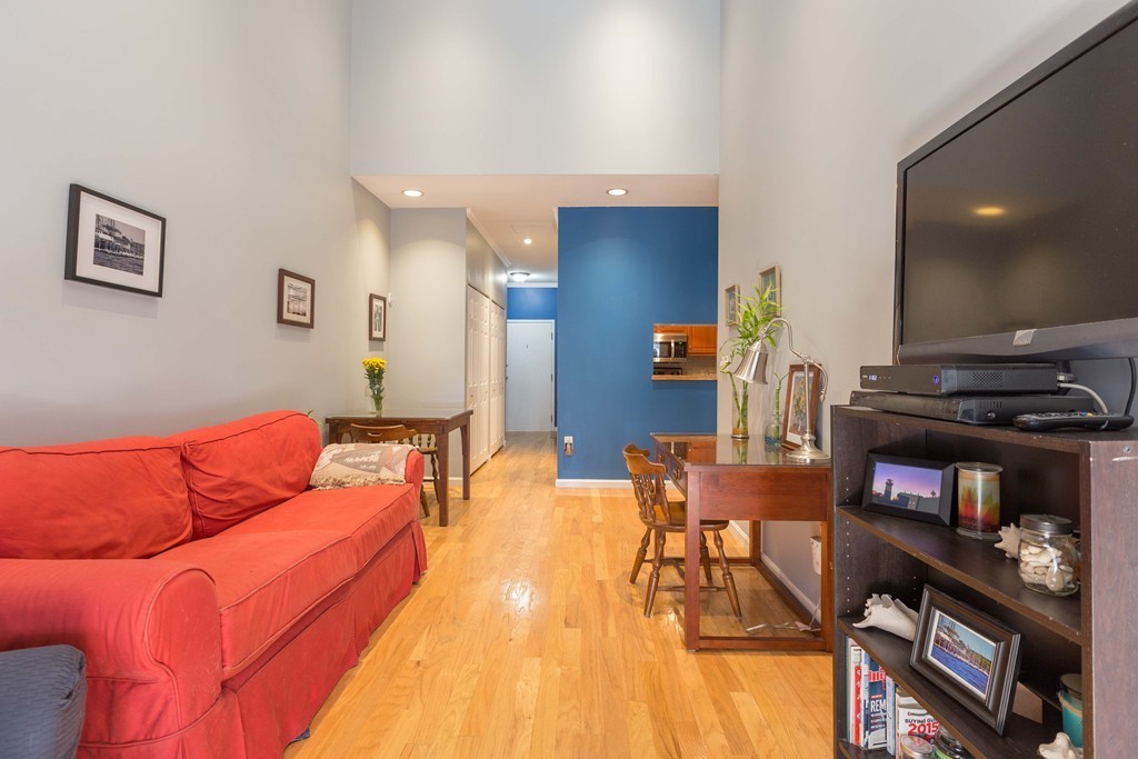 106 13th Street, Unit 204 Boston, MA 02129 - Photo 4 of 21 a living room with furniture and a fireplace