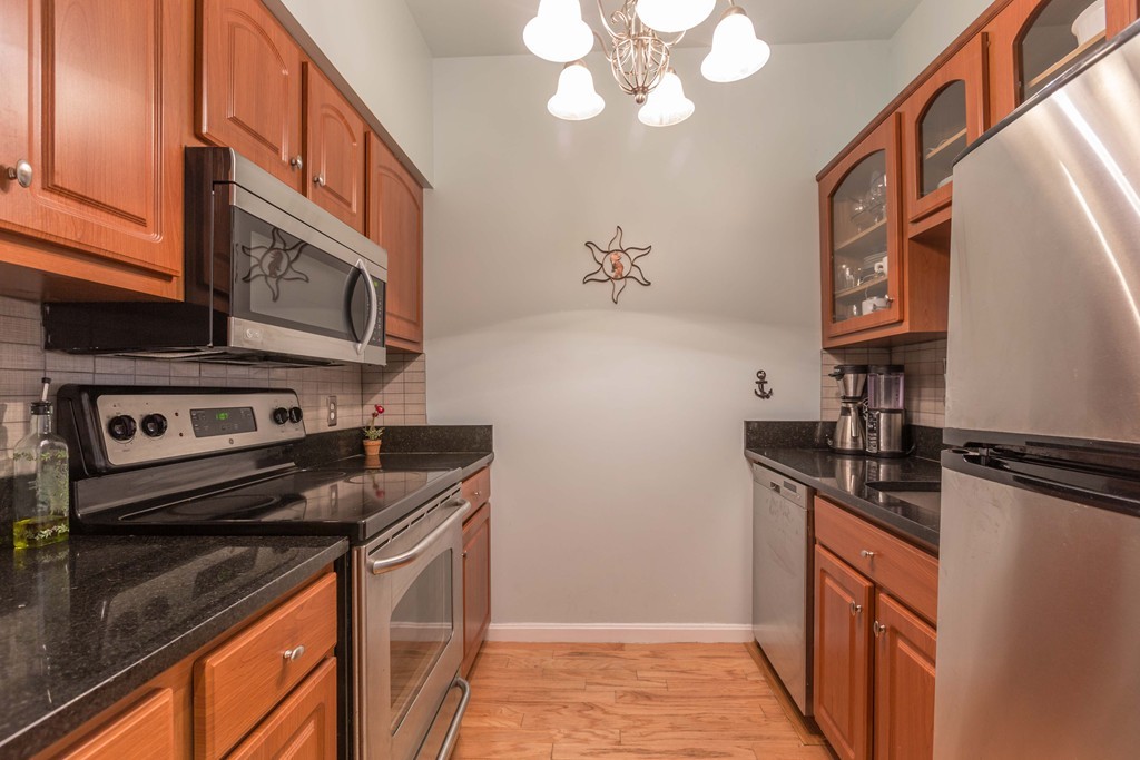 106 13th Street, Unit 204 Boston, MA 02129 - Photo 7 of 21 a kitchen with stainless steel appliances granite countertop a stove and a microwave