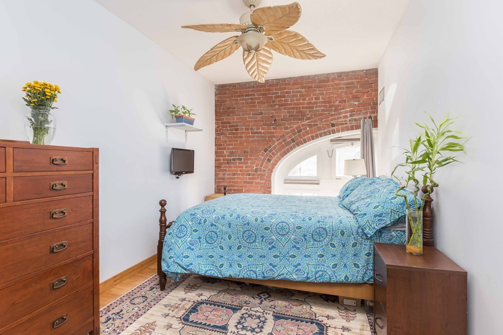106 13th Street, Unit 204 Boston, MA 02129 - Photo 9 of 21 a living room with furniture and a fireplace