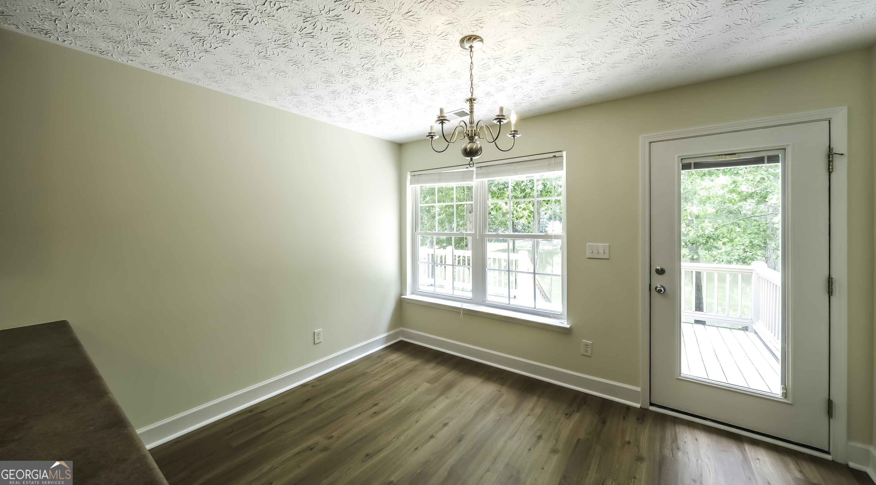 191 Tumlin Creek Road Roopville, GA 30170 - Photo 11 of 49 a view of empty room with wooden floor and fan