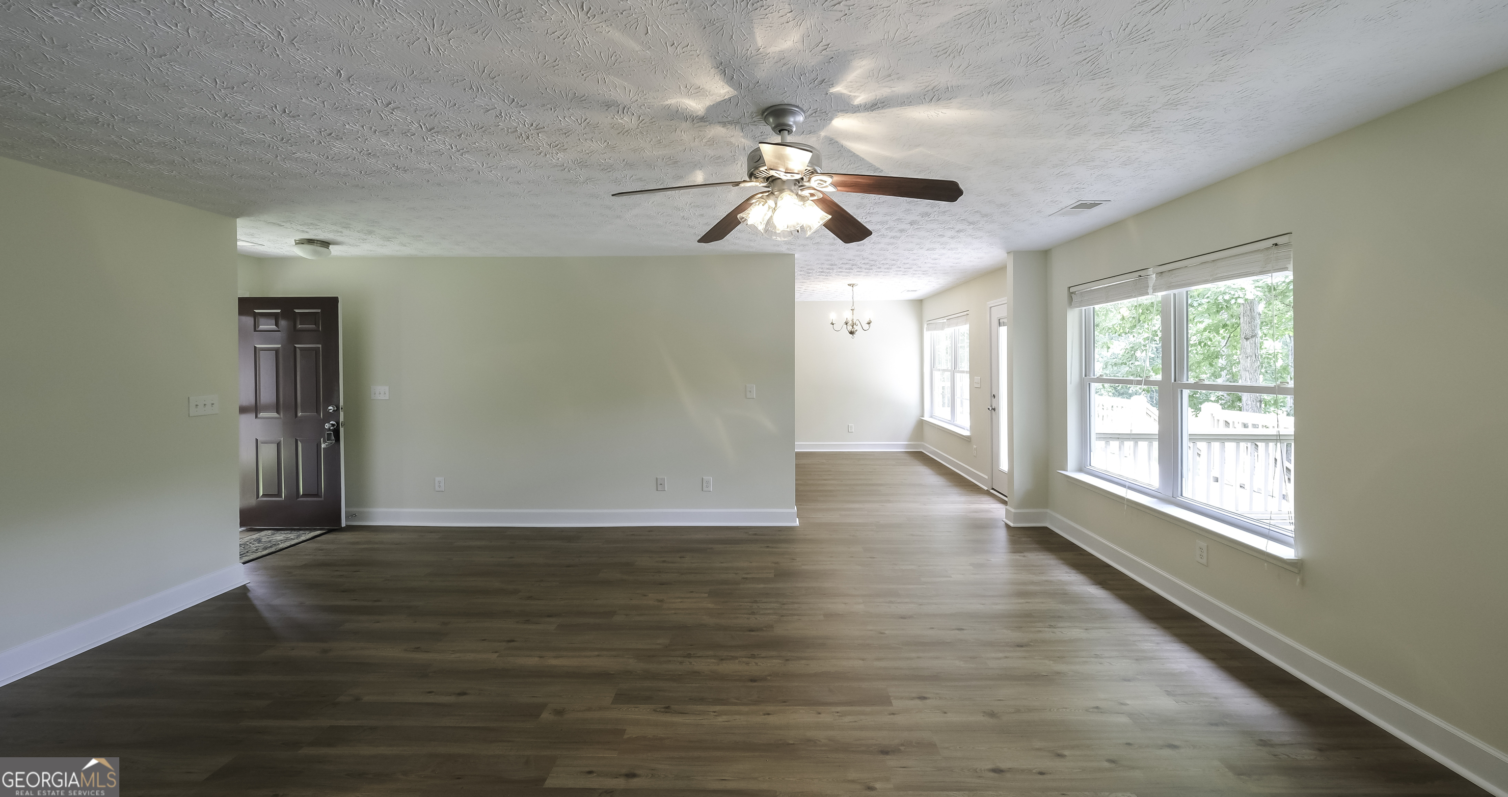 191 Tumlin Creek Road Roopville, GA 30170 - Photo 12 of 49 a view of empty room with wooden floor and fan