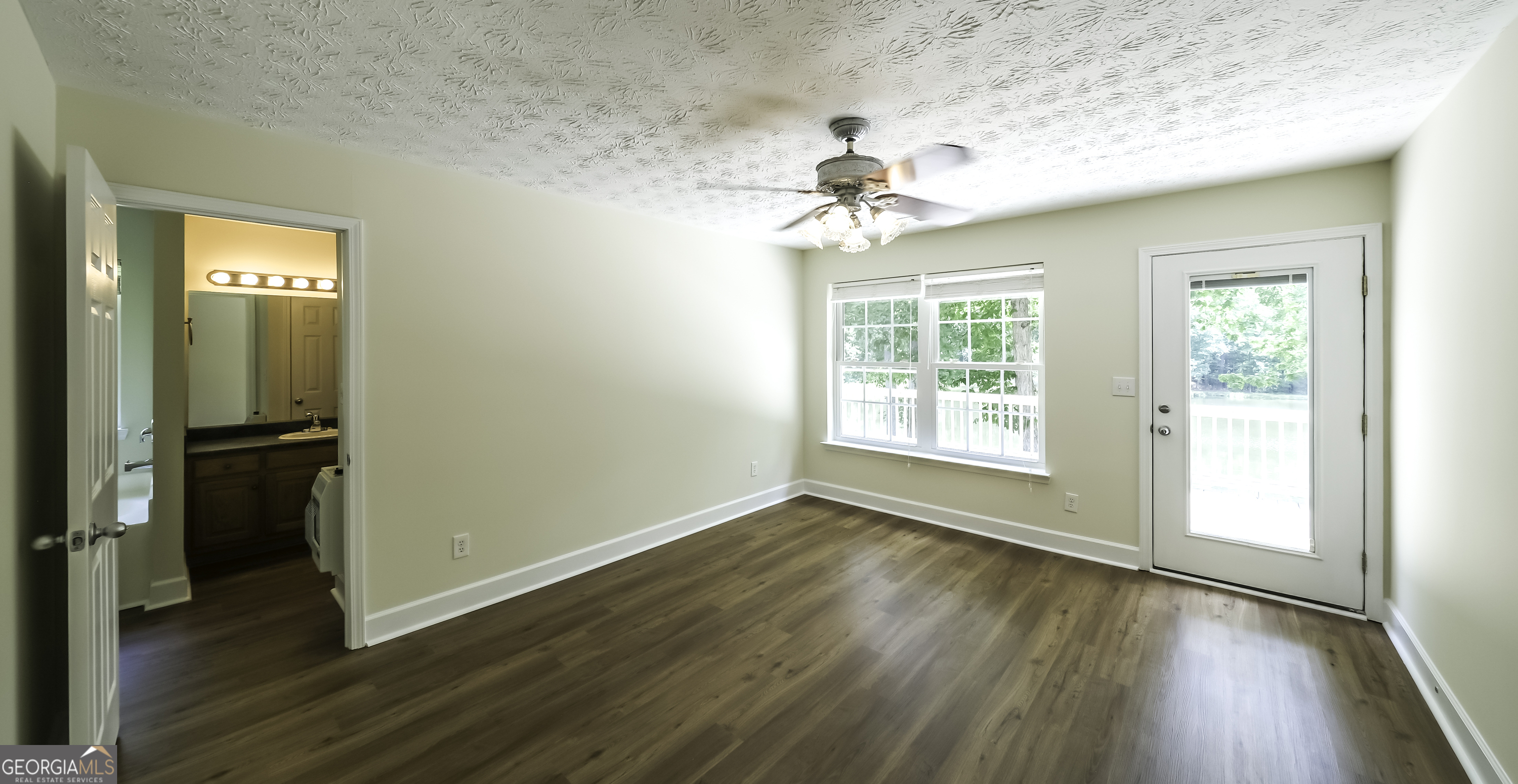 191 Tumlin Creek Road Roopville, GA 30170 - Photo 15 of 49 wooden floor in an empty room with a window