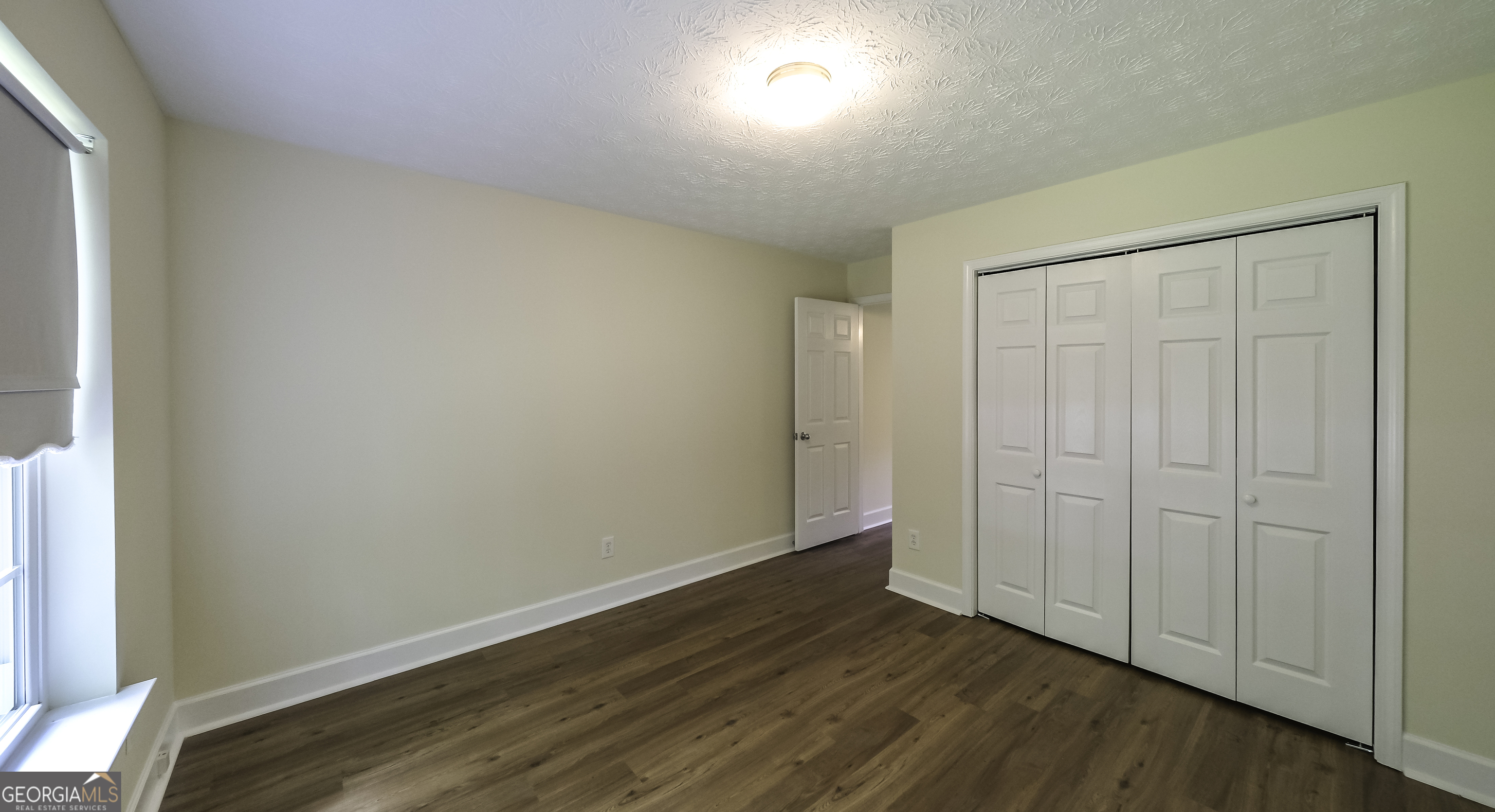 191 Tumlin Creek Road Roopville, GA 30170 - Photo 17 of 49 a view of an empty room with wooden floor