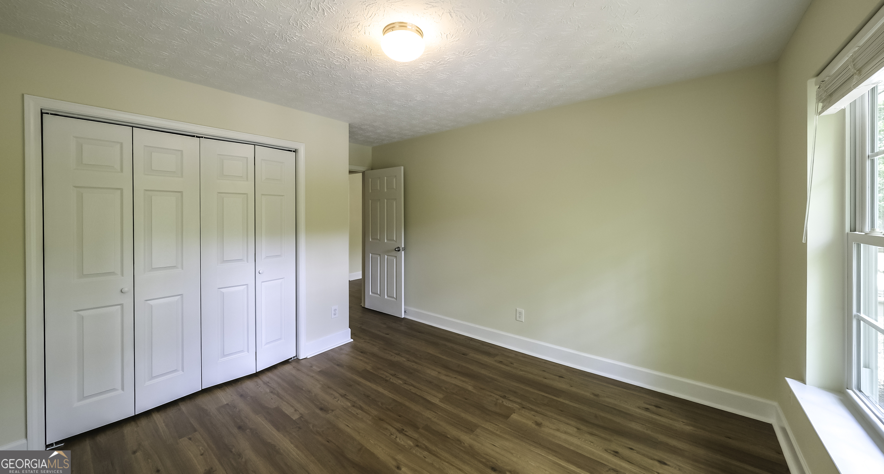 191 Tumlin Creek Road Roopville, GA 30170 - Photo 19 of 49 a view of an empty room with wooden floor