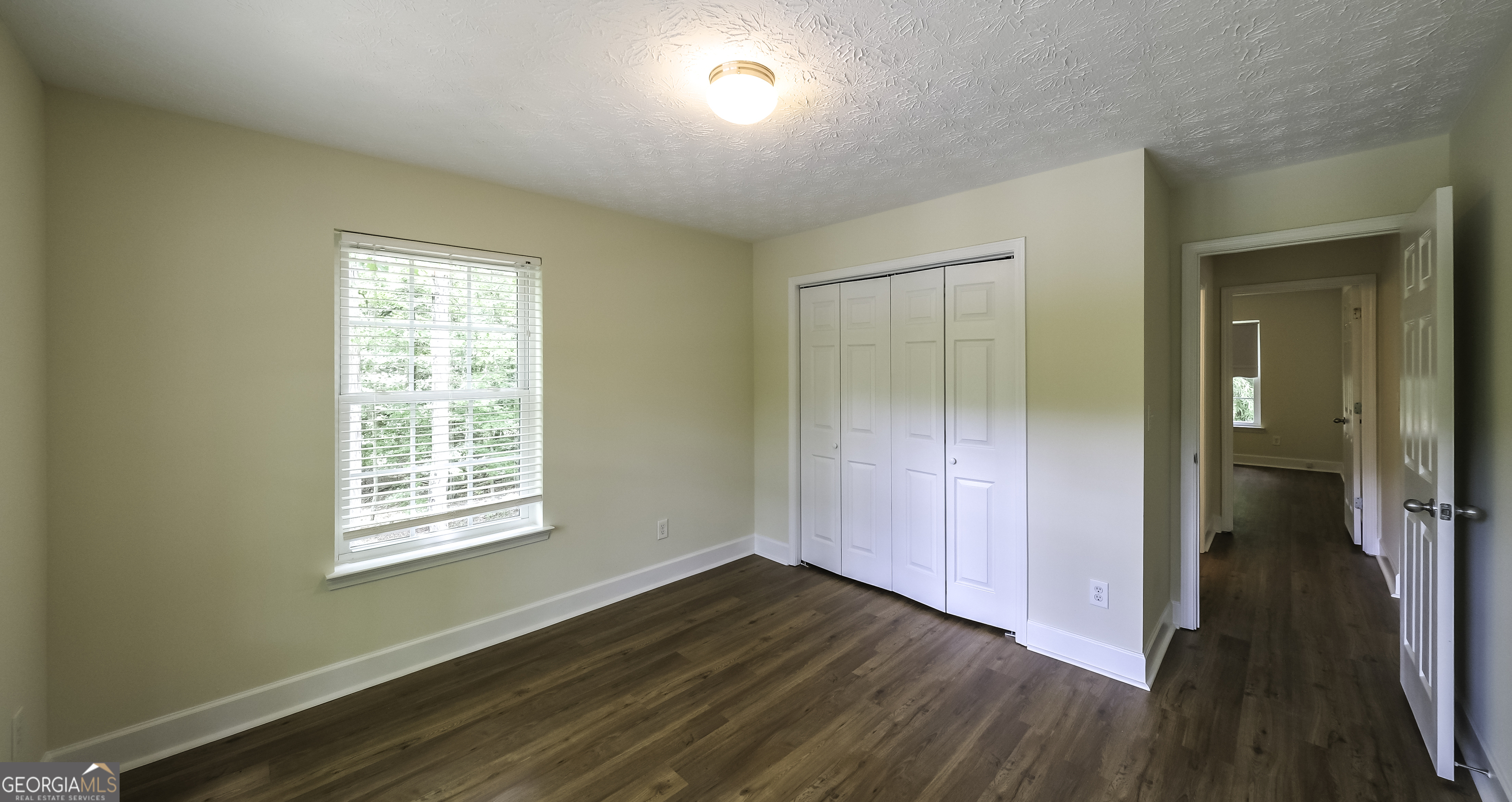 191 Tumlin Creek Road Roopville, GA 30170 - Photo 21 of 49 a view of an empty room with wooden floor and a window