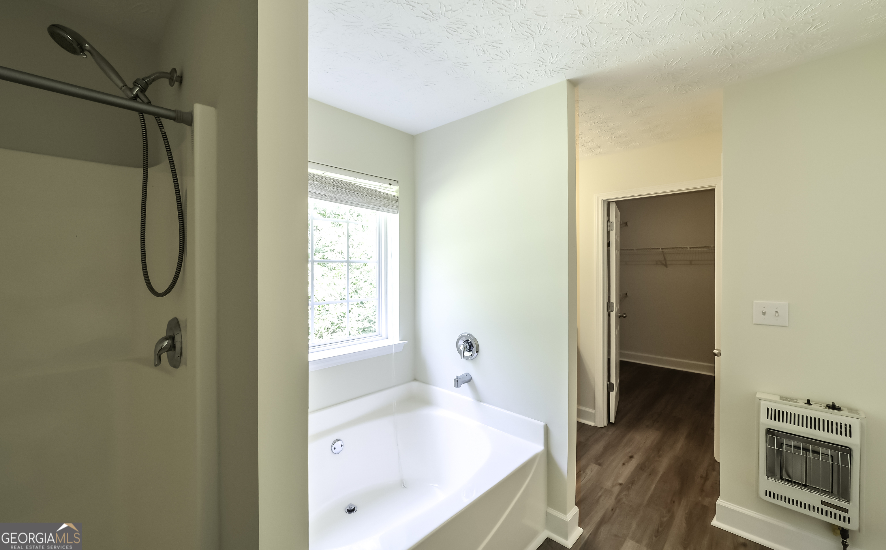 191 Tumlin Creek Road Roopville, GA 30170 - Photo 26 of 49 a bathroom with a bathtub and a shower