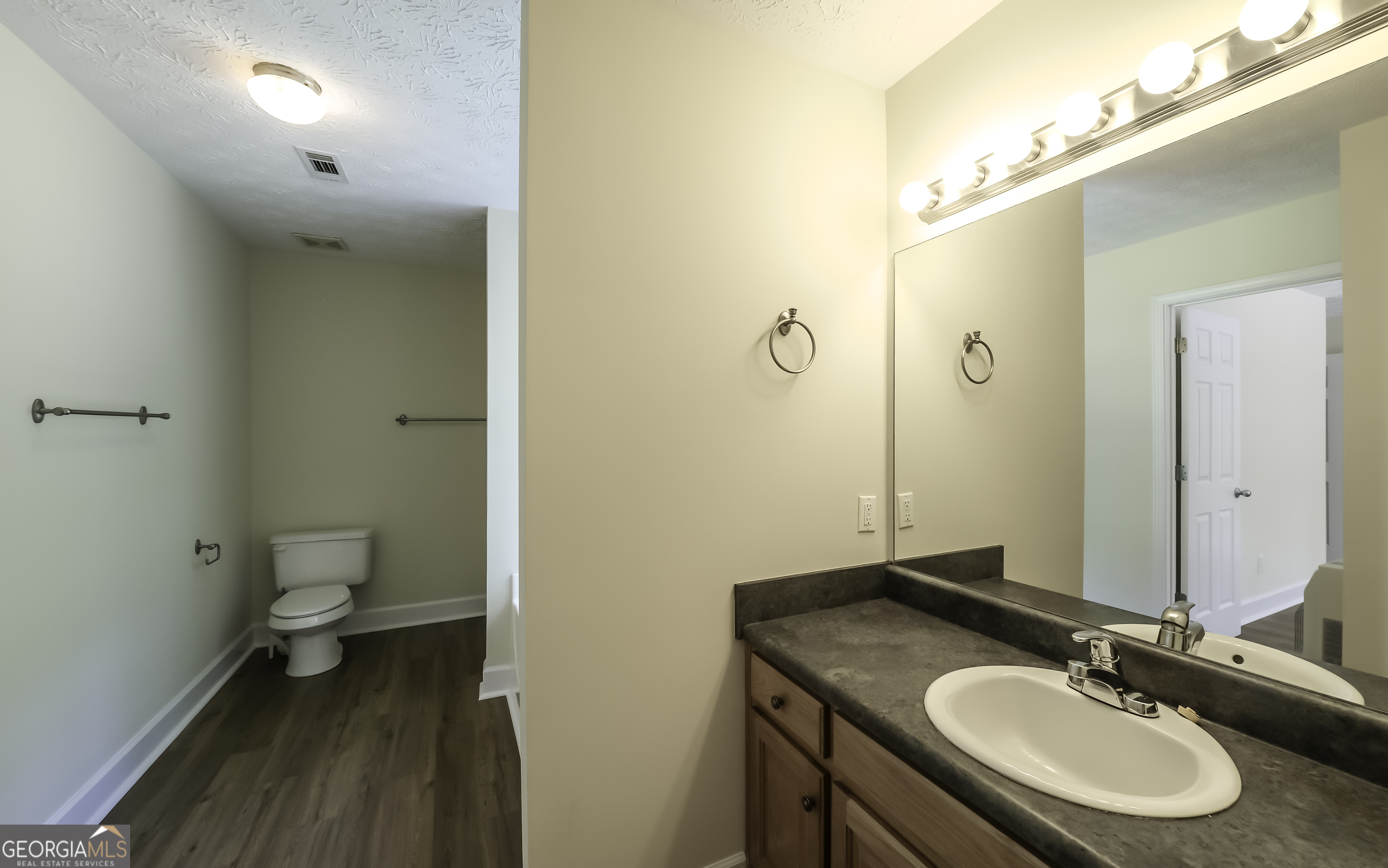 191 Tumlin Creek Road Roopville, GA 30170 - Photo 28 of 49 a bathroom with a granite countertop sink toilet and shower