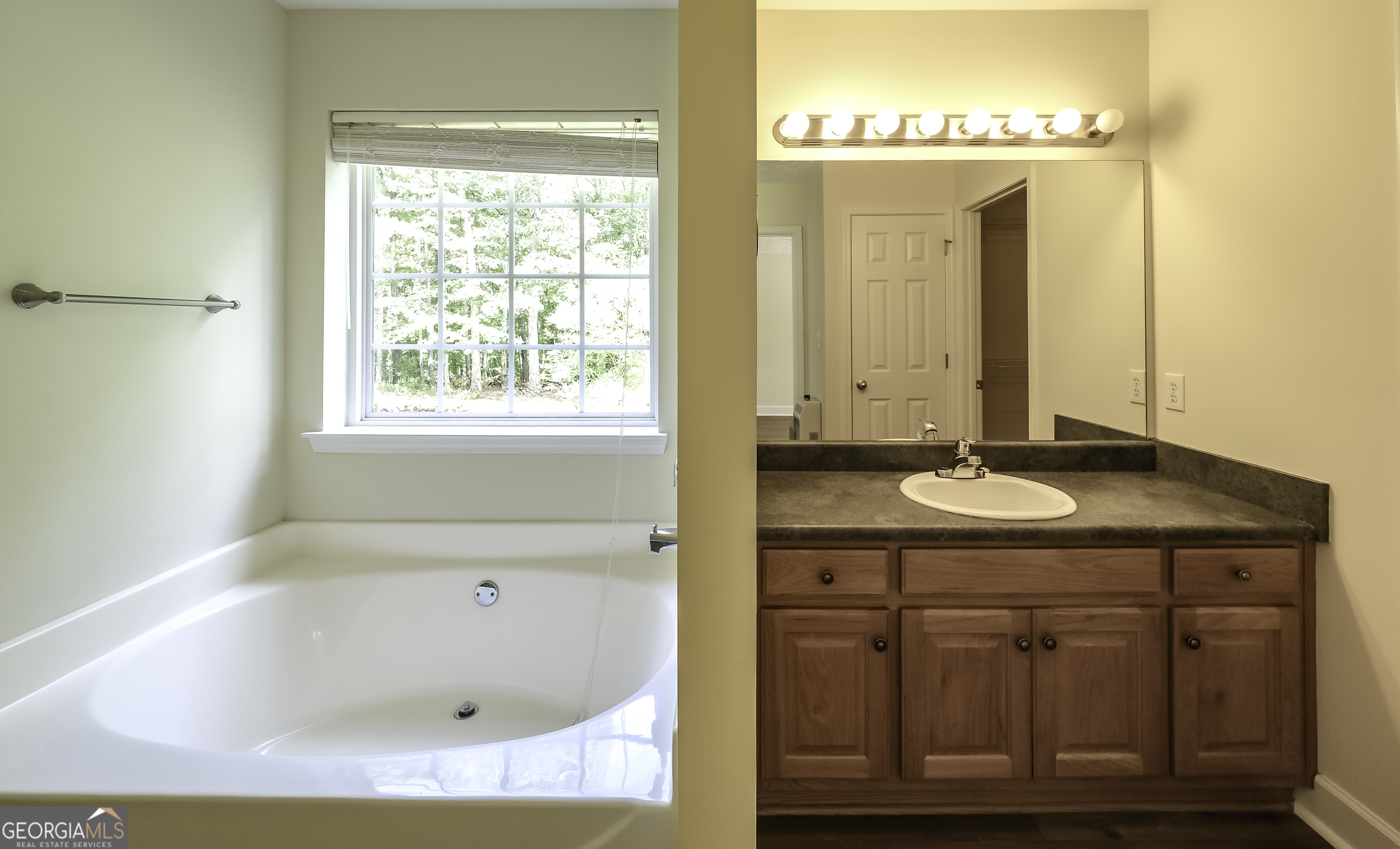 191 Tumlin Creek Road Roopville, GA 30170 - Photo 29 of 49 a bathroom with a granite countertop sink and a mirror