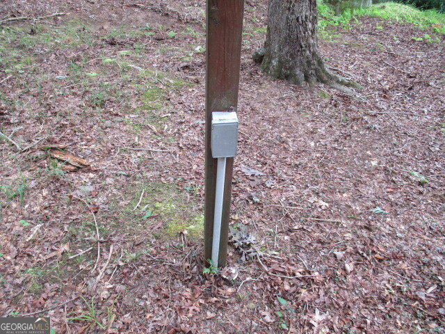 191 Tumlin Creek Road Roopville, GA 30170 - Photo 41 of 49 a street sign on a rock