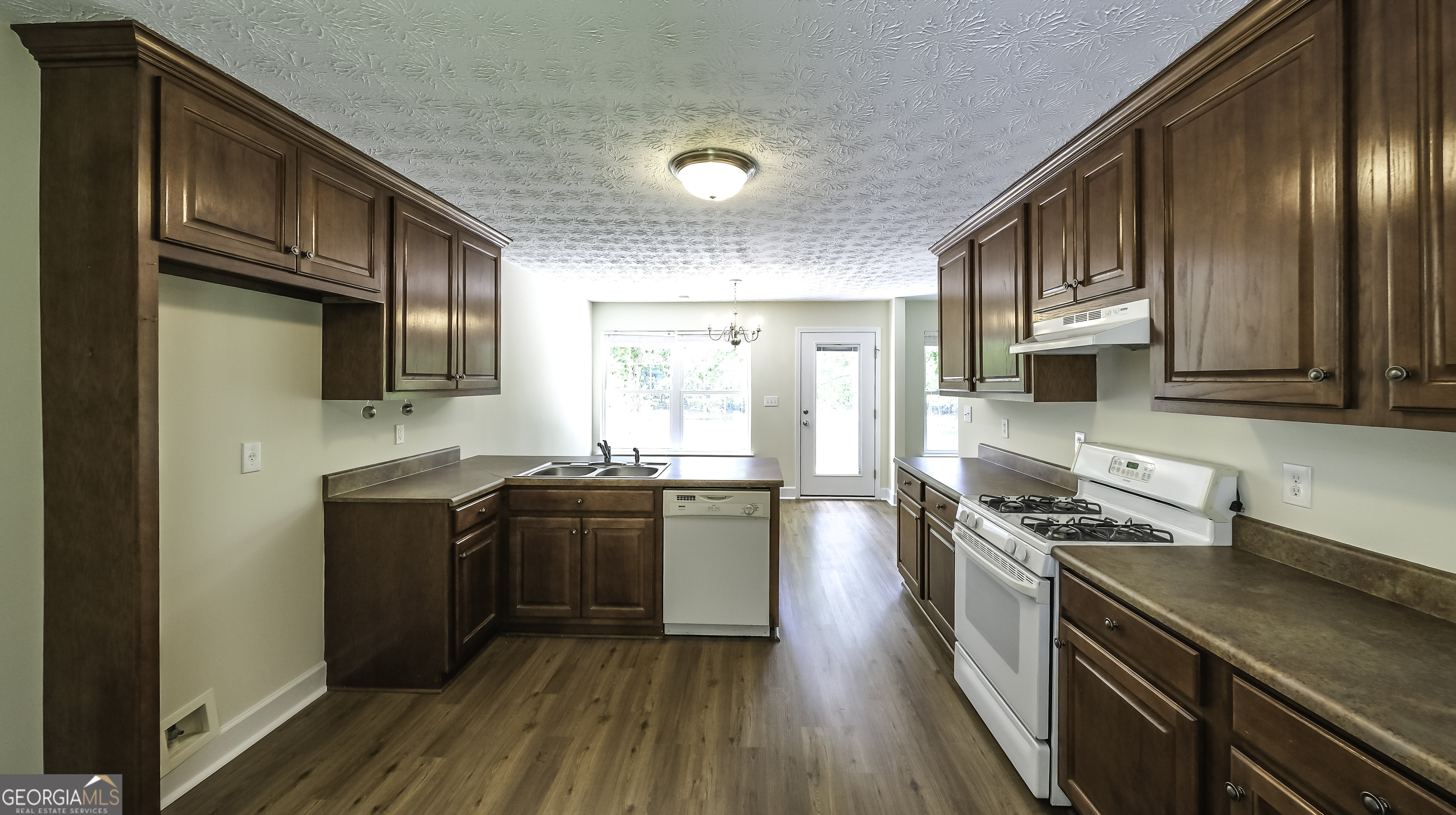 191 Tumlin Creek Road Roopville, GA 30170 - Photo 5 of 49 a kitchen with stainless steel appliances granite countertop wooden cabinets a stove top oven a sink and dishwasher