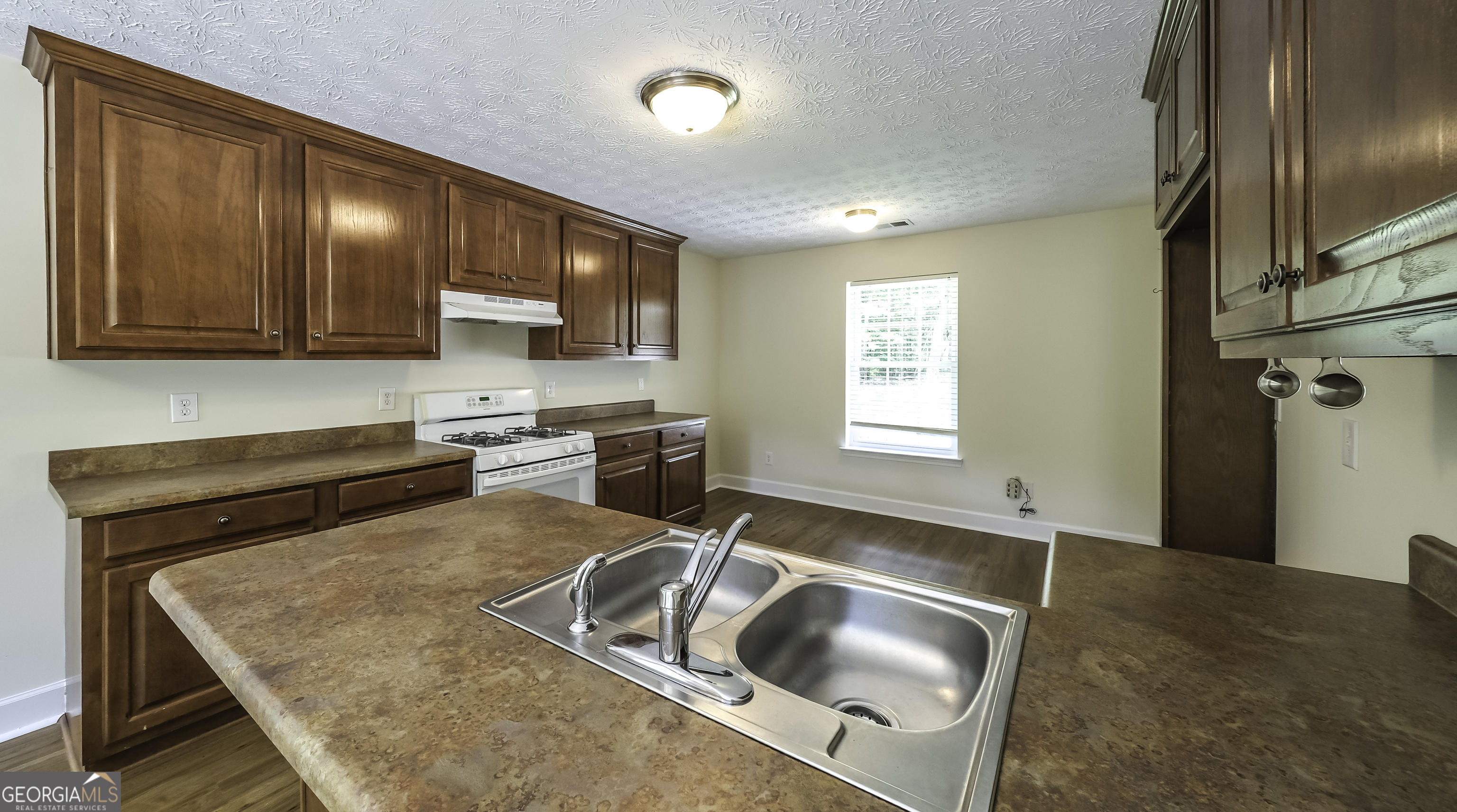 191 Tumlin Creek Road Roopville, GA 30170 - Photo 9 of 49 a kitchen with stainless steel appliances granite countertop a sink stove and refrigerator