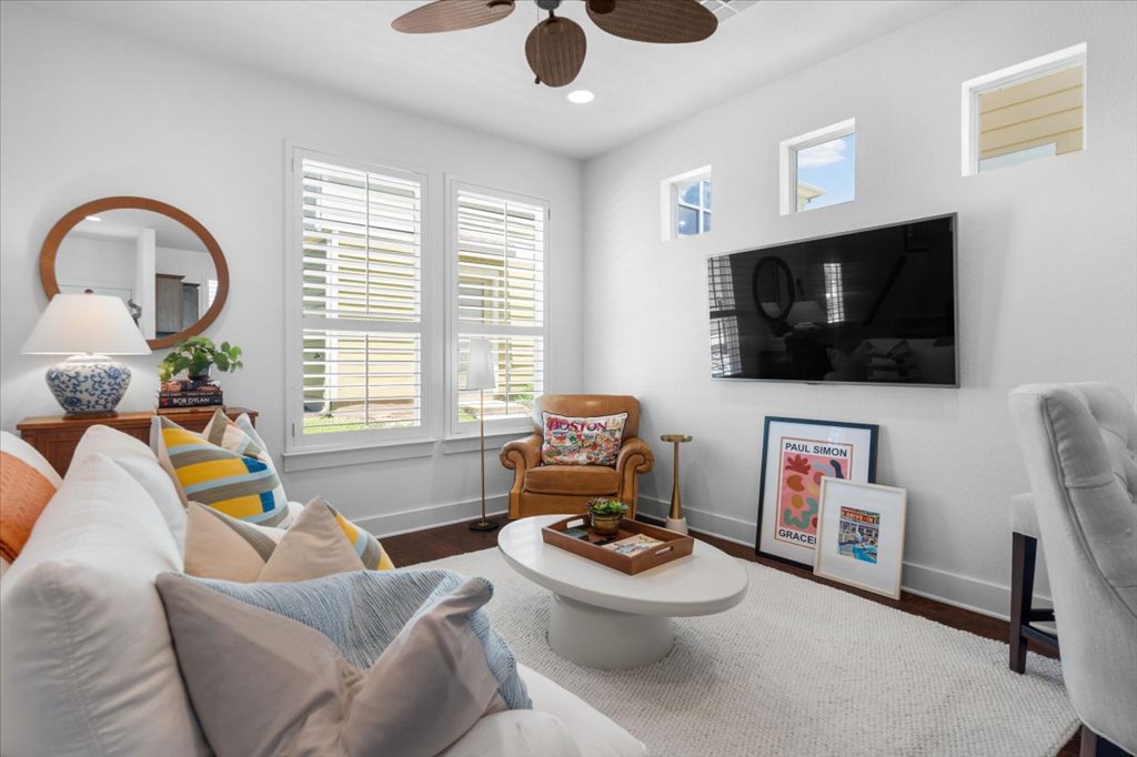 12200 Tawny Farms Road, Unit 139 Austin, TX 78748 - Photo 7 of 30 This living room is all about comfort and light! The square footprint makes furniture arranging a breeze. Look at these gorgeous oversized windows—outfitted with premium plantation shutters—and those high transom windows above the TV that pull in extra sunlight while keeping your privacy completely intact.