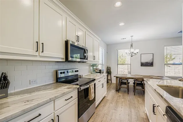 a kitchen with a sink stove and microwave