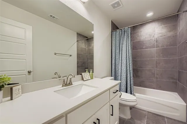 a spacious bedroom with a bed and a window