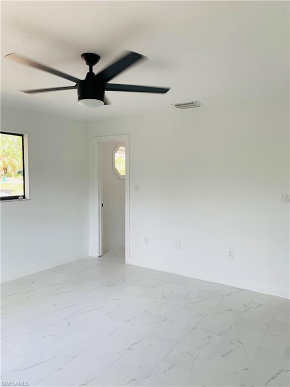 4180 5th Avenue Southwest Naples, FL 34119 - Photo 18 of 33 an empty room with a ceiling fan and a window