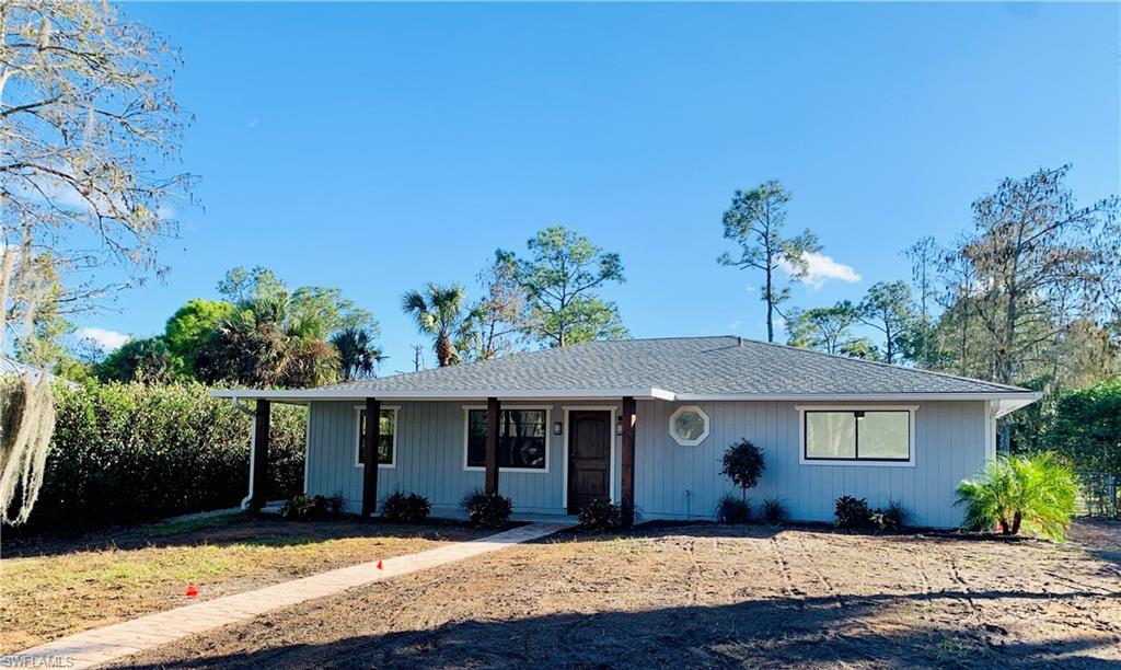 4180 5th Avenue Southwest Naples, FL 34119 - Photo 2 of 33 a front view of a house with a yard