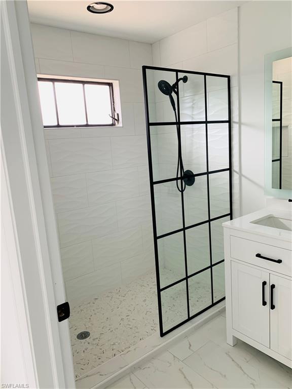4180 5th Avenue Southwest Naples, FL 34119 - Photo 27 of 33 a bathroom with a shower toilet and window