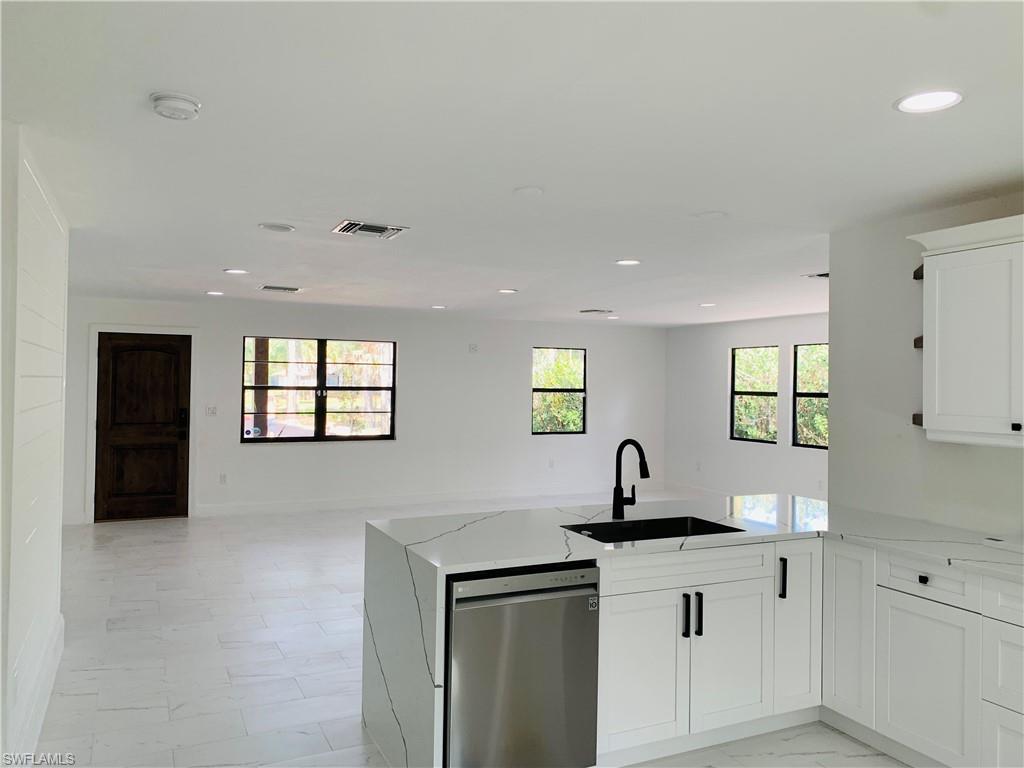 4180 5th Avenue Southwest Naples, FL 34119 - Photo 4 of 33 a kitchen with a sink and cabinets