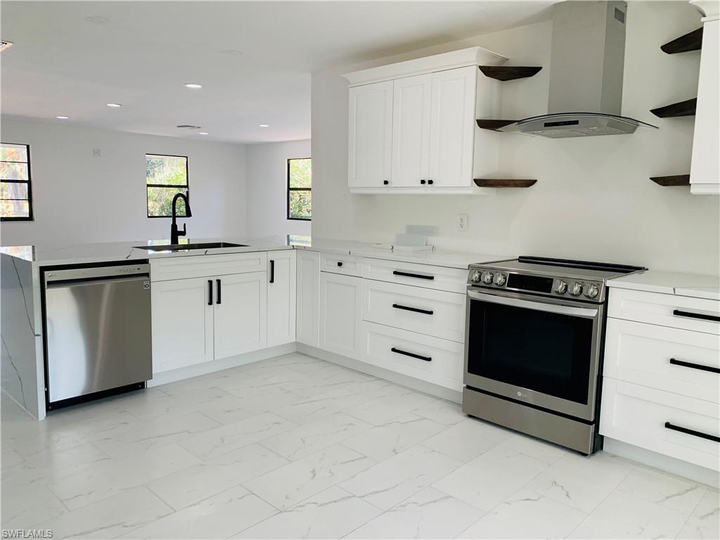 4180 5th Avenue Southwest Naples, FL 34119 - Photo 8 of 33 a kitchen with stainless steel appliances granite countertop a stove and a sink