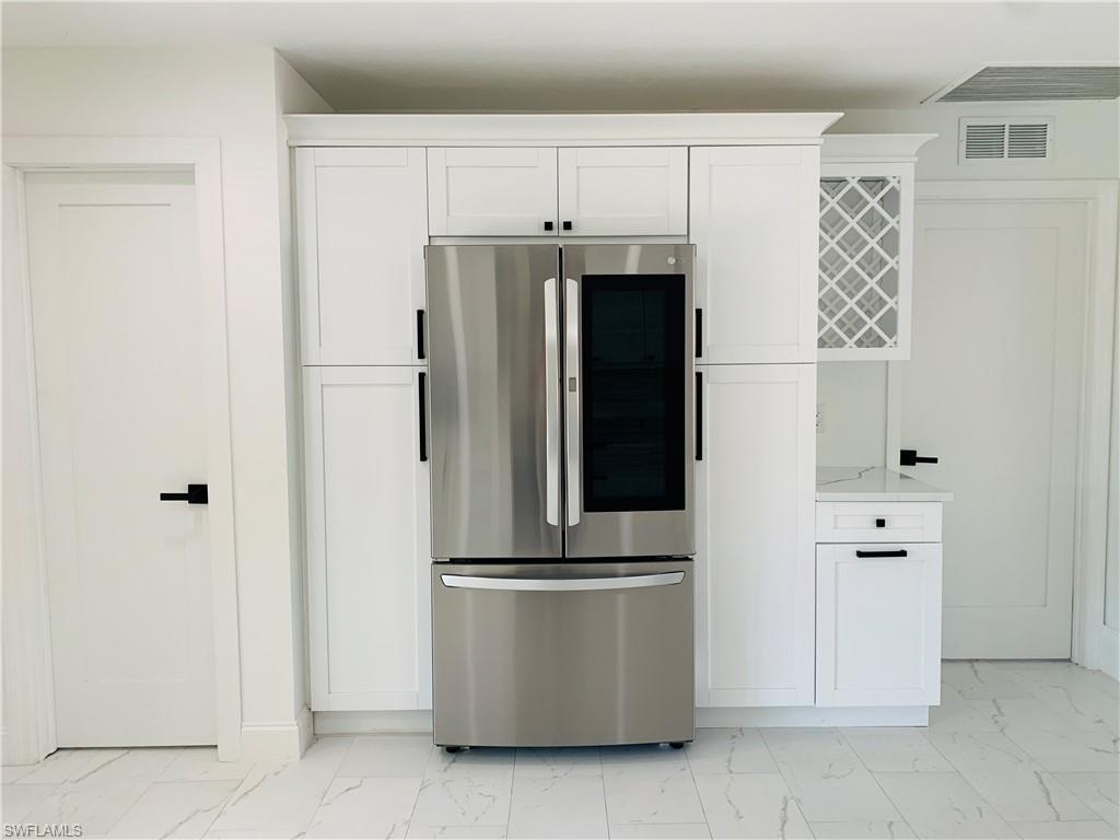 4180 5th Avenue Southwest Naples, FL 34119 - Photo 10 of 33 a refrigerator freezer sitting in a kitchen