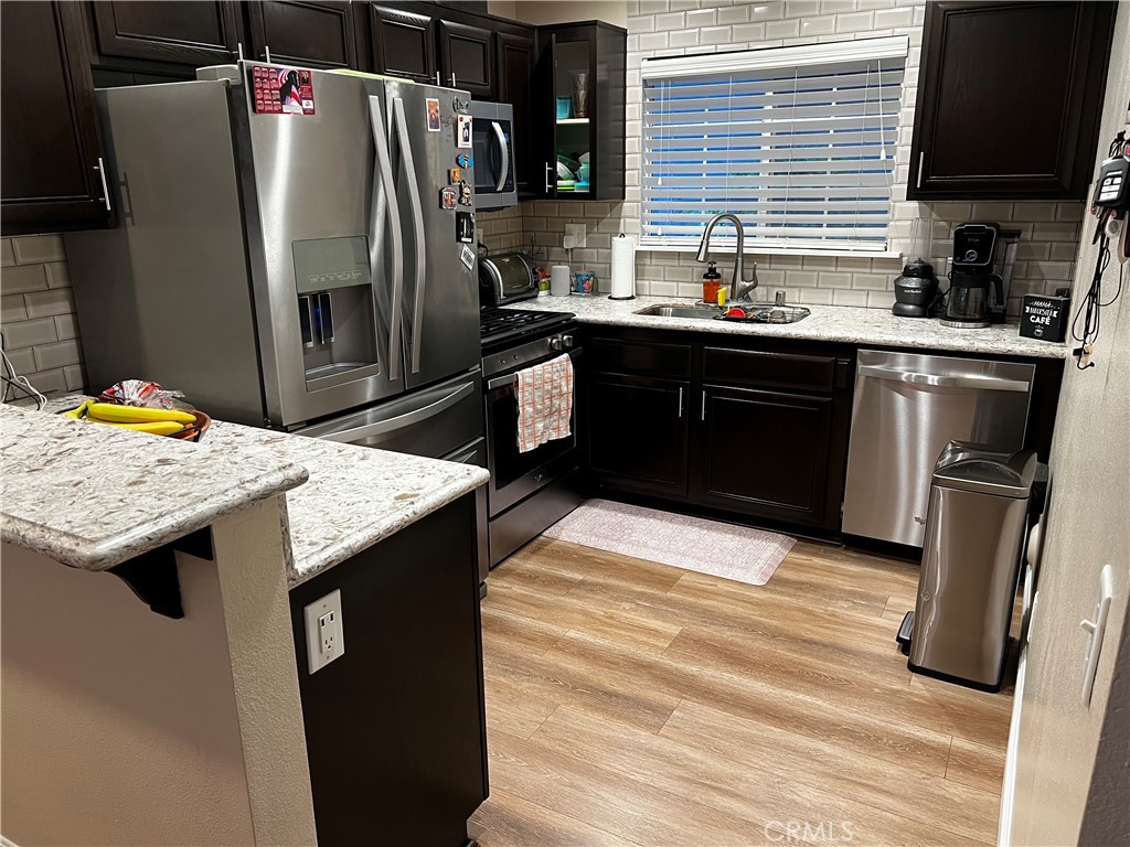1507 Spruce Street, Unit A Placentia, CA 92870 - Photo 4 of 4 a kitchen with stainless steel appliances kitchen island granite countertop a sink stove and refrigerator