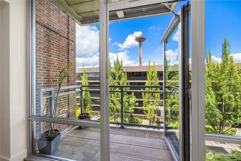 a view of a door with a balcony and a potted plant