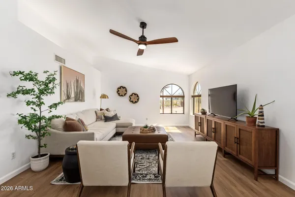a living room with furniture a window and a flat screen tv