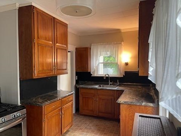 85 Wingold Street Fall River, MA 02720 - Photo 12 of 24 a kitchen with a sink a stove and a refrigerator