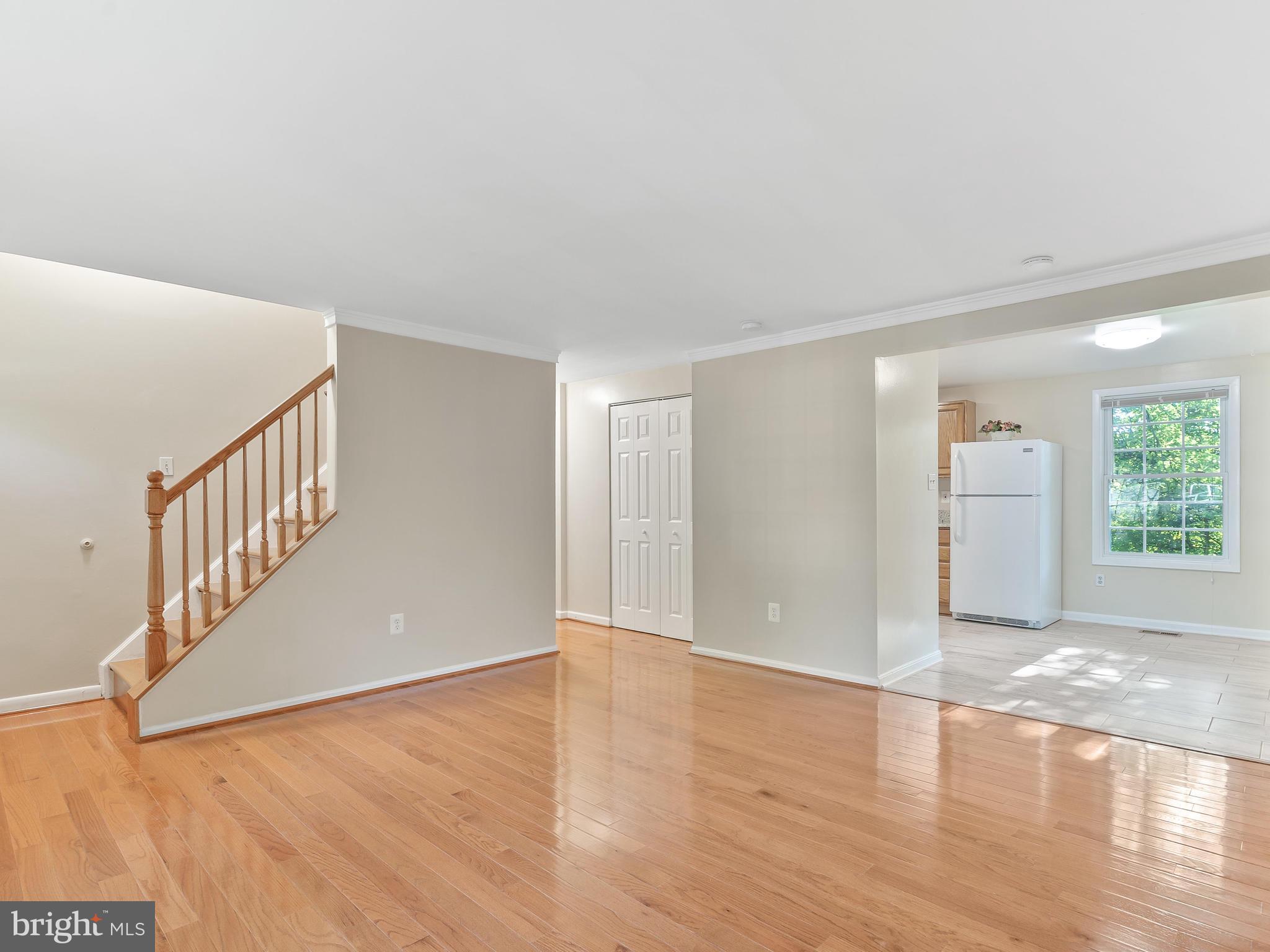 19044 Staleybridge Road Germantown, MD 20876 - Photo 8 of 30 a view of an empty room with window and wooden floor