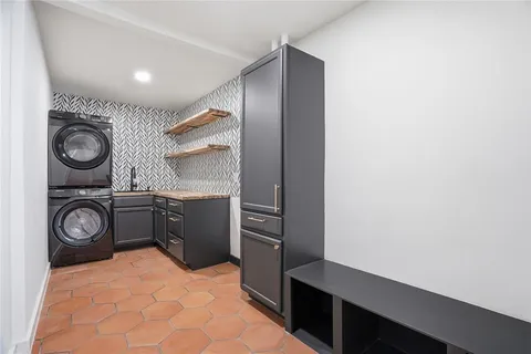 a kitchen with a refrigerator and a stove top oven
