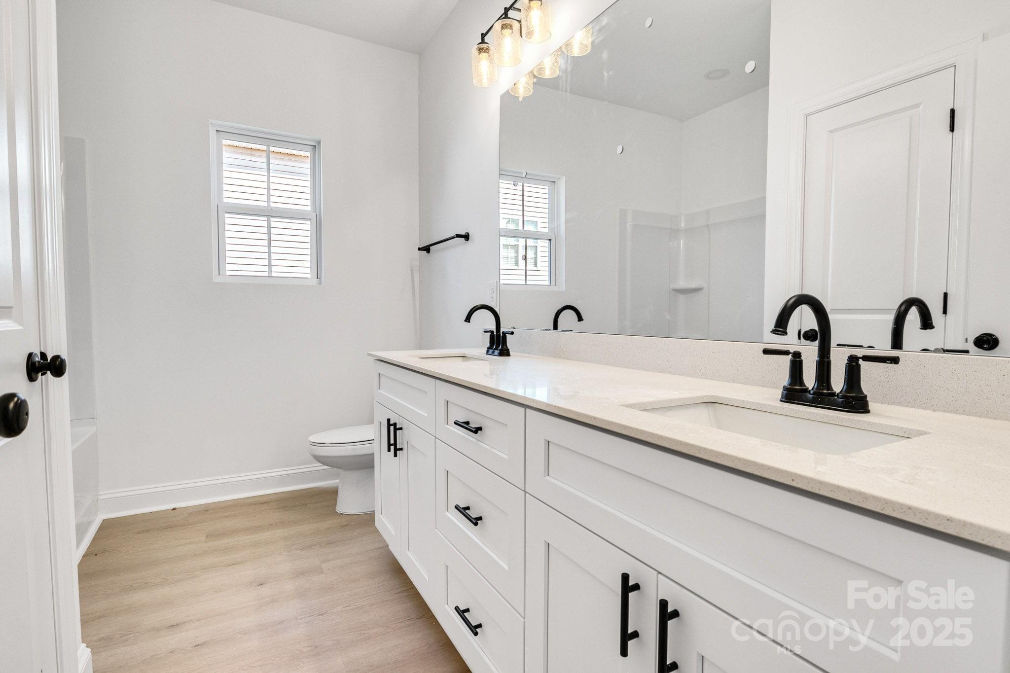 540 Church Street Locust, NC 28097 - Photo 15 of 25 a bathroom with a double vanity sink and a mirror