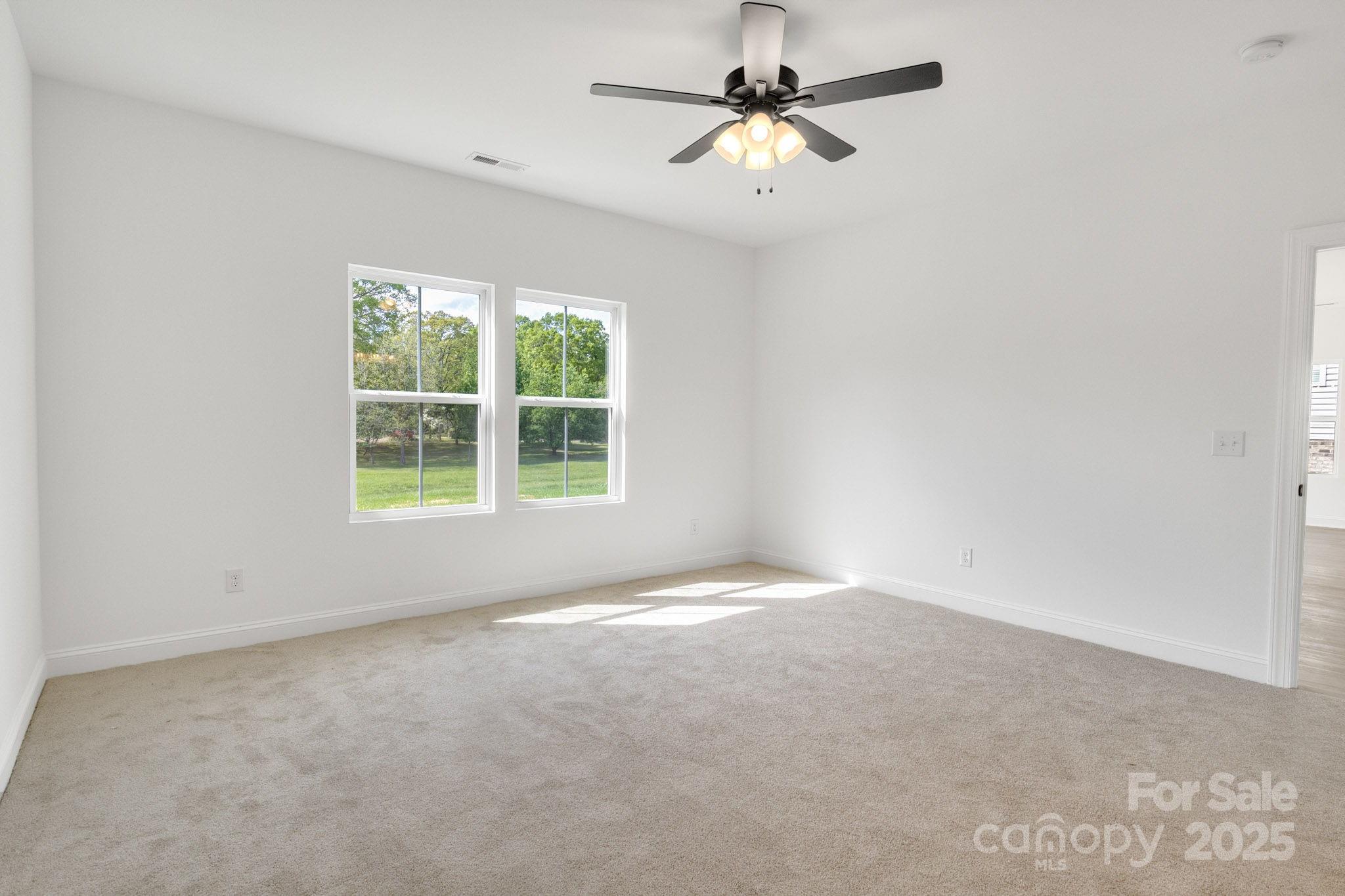 540 Church Street Locust, NC 28097 - Photo 19 of 25 an empty room with a window and a fan