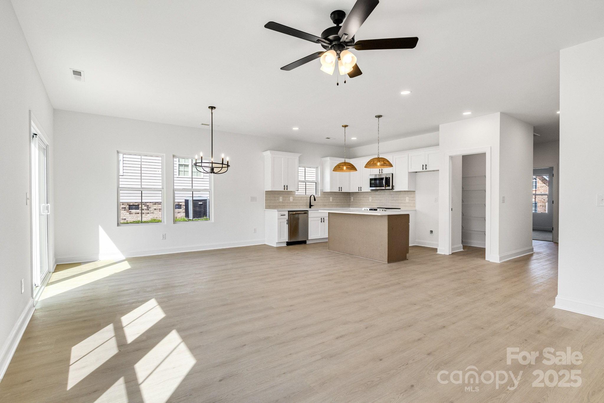 540 Church Street Locust, NC 28097 - Photo 4 of 25 a view of a kitchen with wooden floor and windows