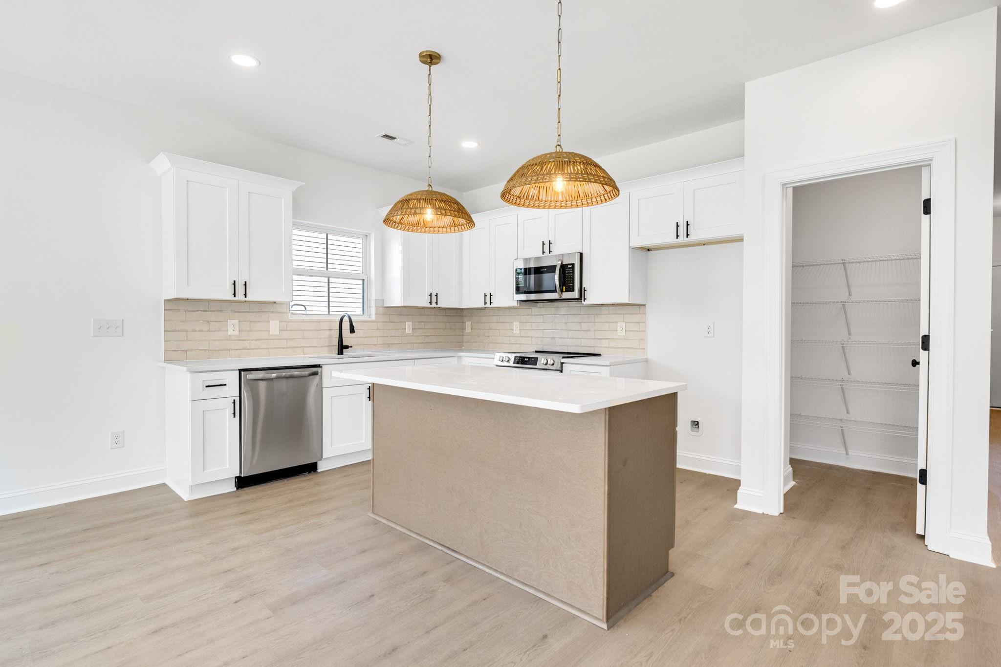 540 Church Street Locust, NC 28097 - Photo 7 of 25 a kitchen with a stove oven and a view of living room