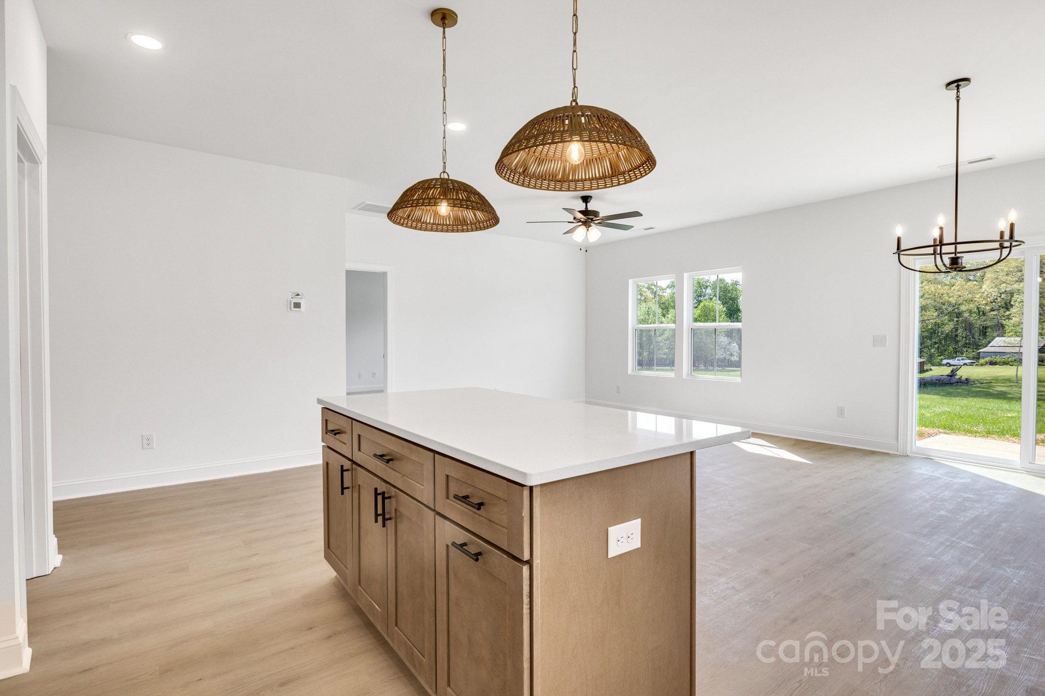 540 Church Street Locust, NC 28097 - Photo 8 of 25 a kitchen with a cabinets and chandelier