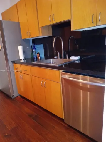 a kitchen with wooden cabinets a sink and dishwasher