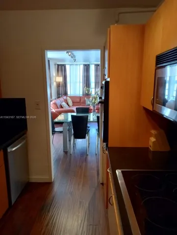 a view of kitchen and dining room with wooden floor