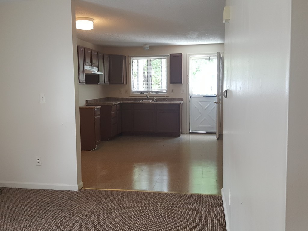 128 Cedar Street Springfield, MA 01105 - Photo 11 of 17 a kitchen with granite countertop a refrigerator and cabinets
