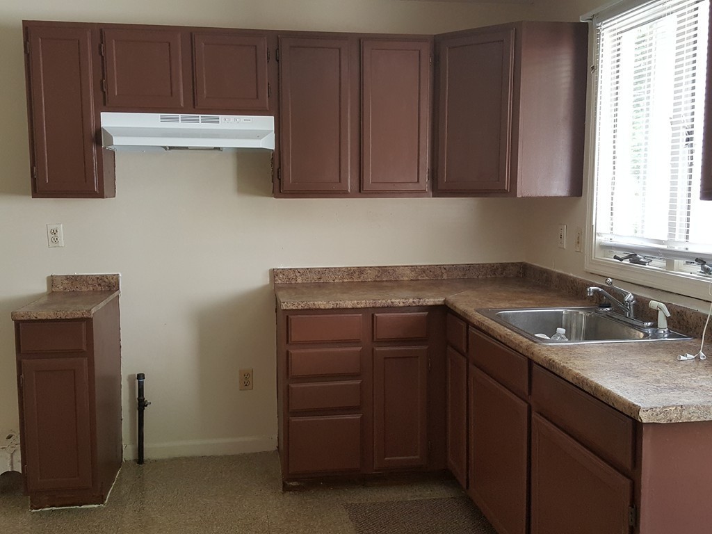 128 Cedar Street Springfield, MA 01105 - Photo 12 of 17 a kitchen with a sink and cabinets