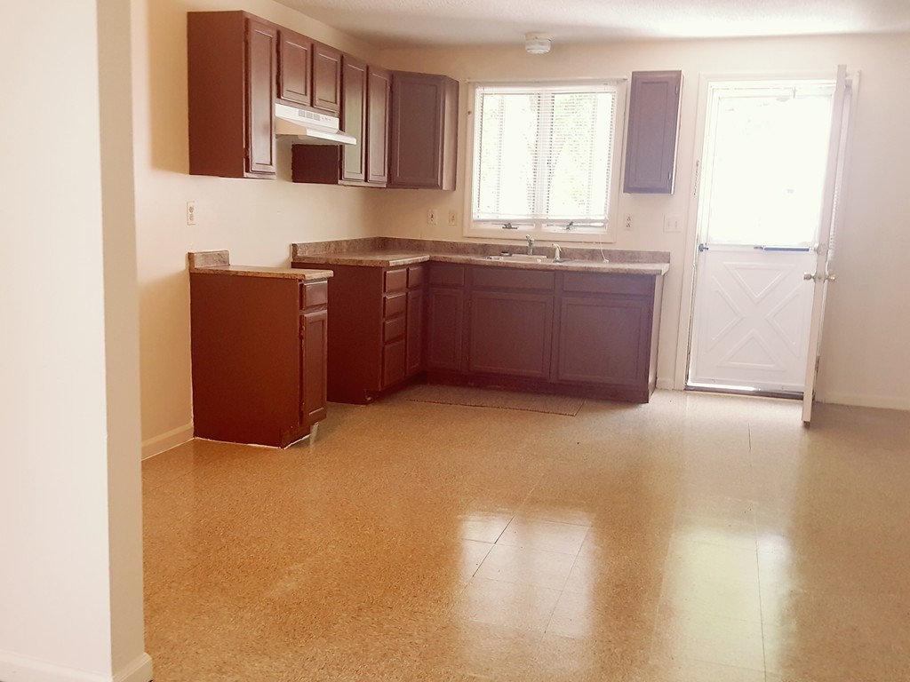 128 Cedar Street Springfield, MA 01105 - Photo 15 of 17 a kitchen with stainless steel appliances granite countertop a stove a sink and a microwave
