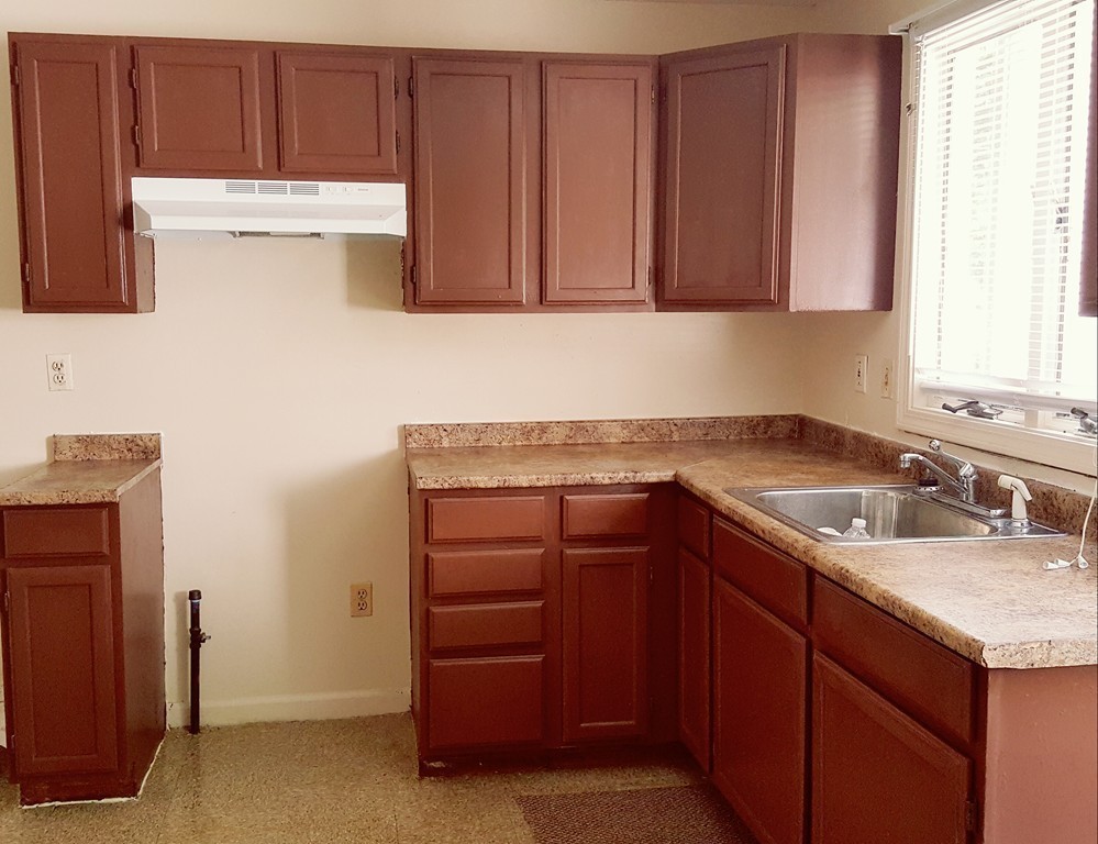 128 Cedar Street Springfield, MA 01105 - Photo 4 of 17 a kitchen with a sink and cabinets