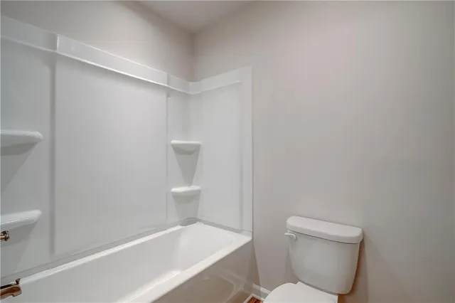 a bathroom with a toilet and a bathtub