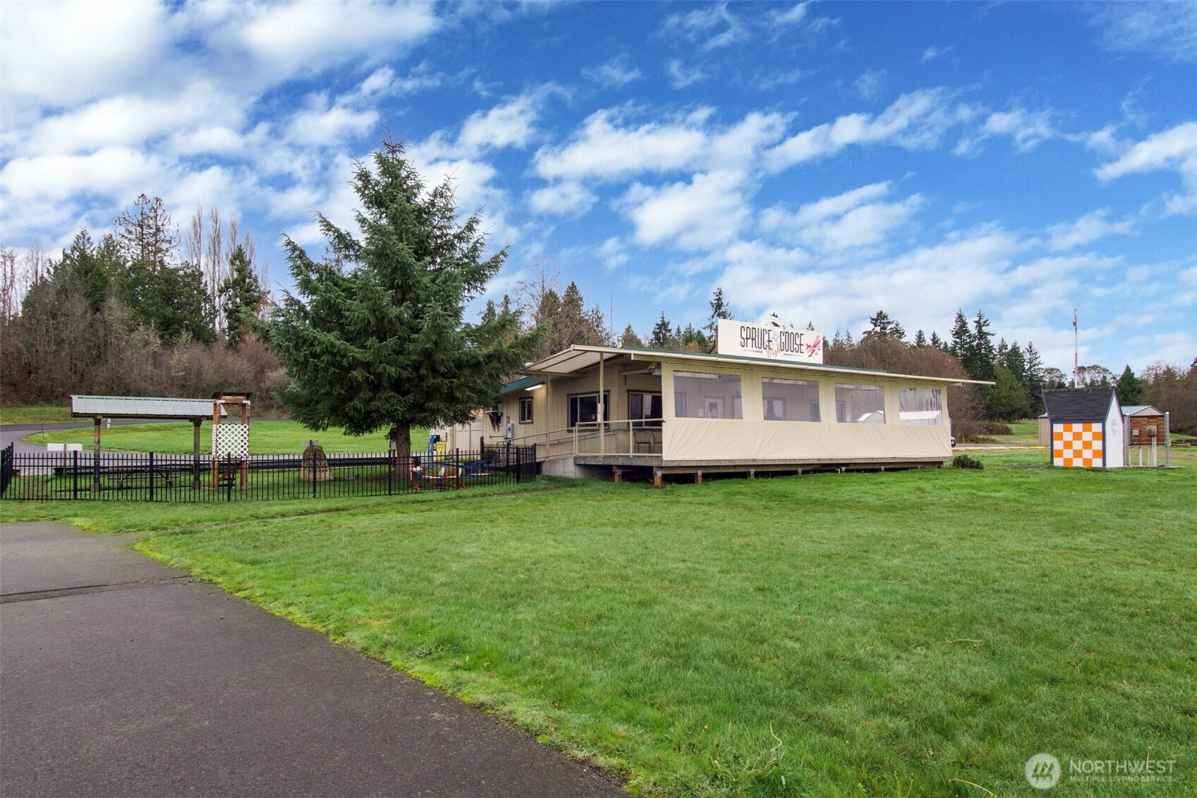 191 Airport Road Port Townsend, WA 98368 - Photo 26 of 27 a view of a house next to a big yard and large trees