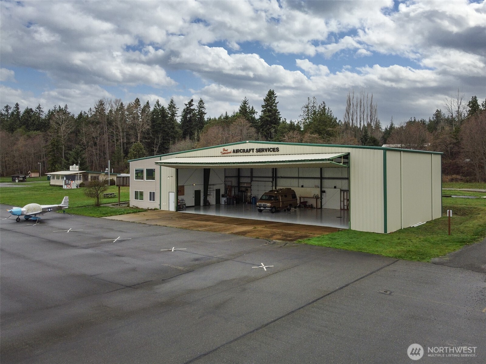 191 Airport Road Port Townsend, WA 98368 - Photo 5 of 27 a view of a big house with a big yard and large trees